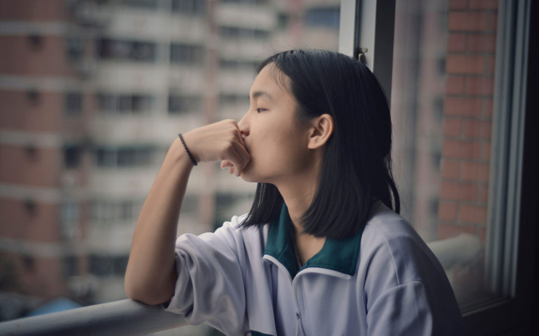 girl thinking by window